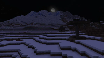 A full moon over snowy slopes