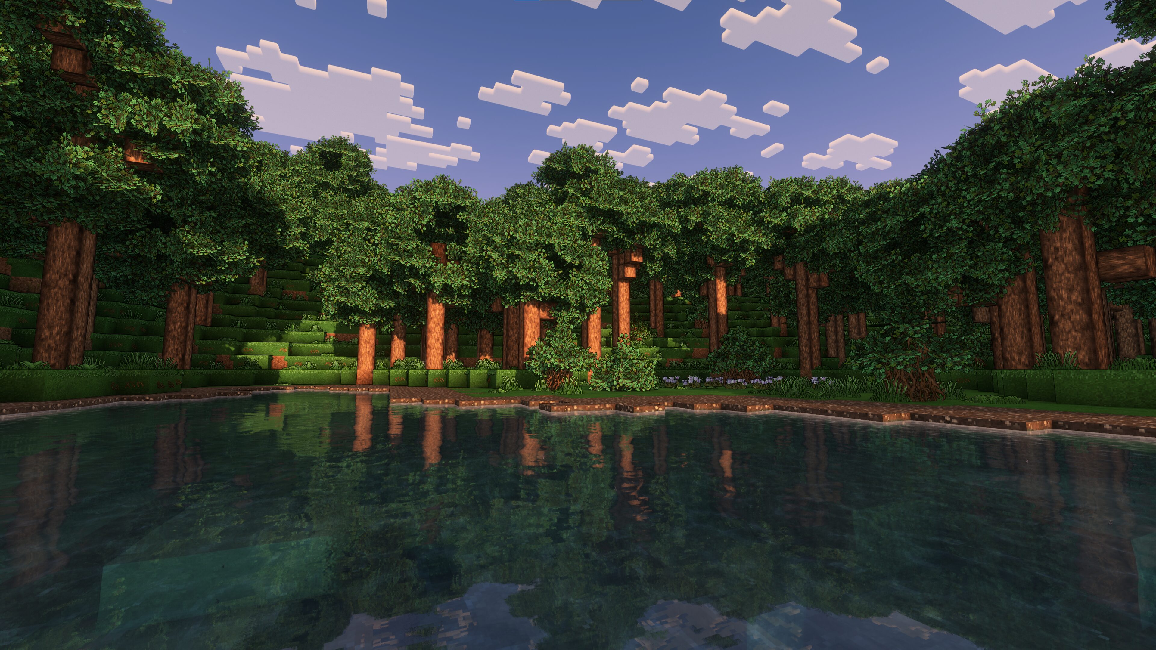 A calm inlet surrounded by trees.
