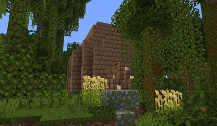 a monument like building buried in the rainforest foliage