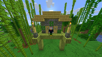A player outside a bamboo house